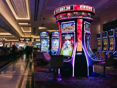Rows of illuminated slot machines in a casino